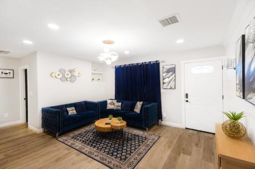 a living room with a blue couch and a table at Exotic Home Escondido 3 Bedroom by sdstay in Escondido