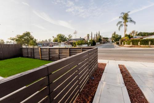 a fence in front of a road with a yard at Exotic Home Escondido 3 Bedroom by sdstay in Escondido