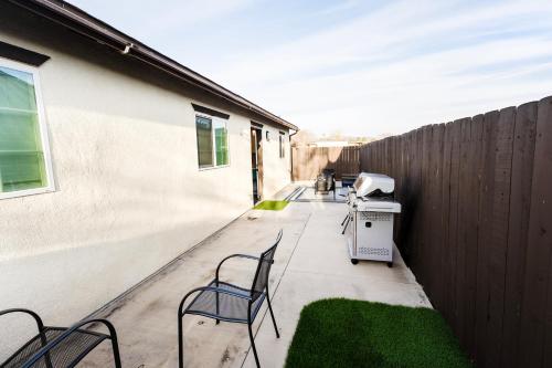 a patio with two chairs and a fence at Exotic Home Escondido 3 Bedroom by sdstay in Escondido