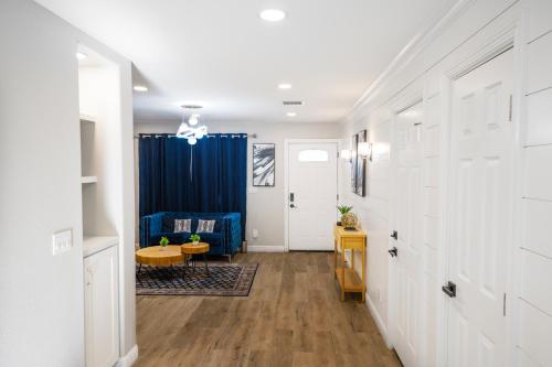 a hallway with white walls and a blue curtain at Exotic Home Escondido 3 Bedroom by sdstay in Escondido