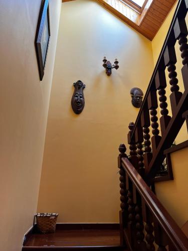 a hallway with a staircase with vases on the wall at Hotel Casa Alberto in Castro Caldelas