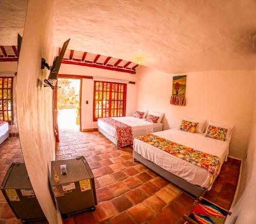 a bedroom with two beds in a room at Casa Aminta in Curití