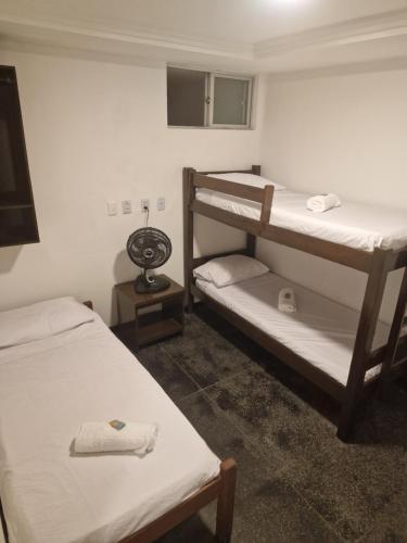 a room with two bunk beds and a mirror at Hotel Bela Vista in Salvador