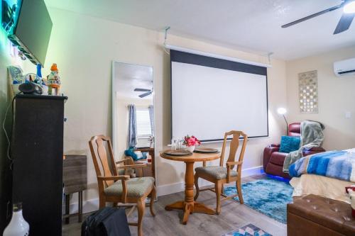 a living room with a table and chairs and a couch at Hidden Gem Luxe 1 BEDROOM & Patio in Cutler Bay