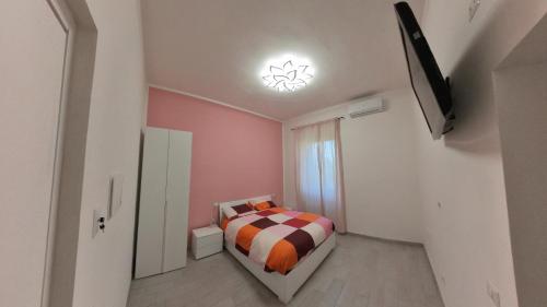 a small bedroom with a bed and a television at La Stazione Sabina Alloggio Turistico in Stimigliano