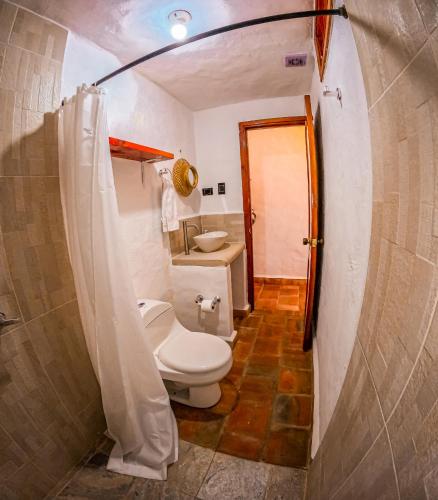 a bathroom with a toilet and a sink at Casa Aminta in Curití