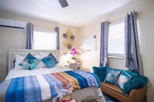 a bedroom with a bed with blue and white blankets and pillows at Hidden Gem Luxe 1 BEDROOM & Patio in Cutler Bay