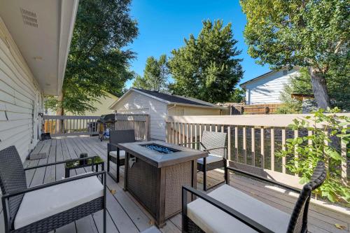 a deck with chairs and a table and a grill at Cheerful Chalet Centrally Located w BBQ Pit in Colorado Springs