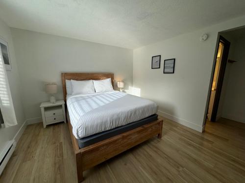 a bedroom with a bed with a wooden bed frame at San Dune Inn in Manzanita