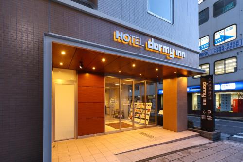 a store front of a building with a sign on it at Dormy Inn Matsumoto in Matsumoto