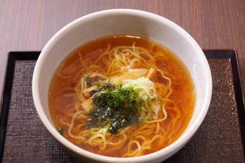 a white bowl of soup with noodles and vegetables at Dormy Inn Matsumoto in Matsumoto