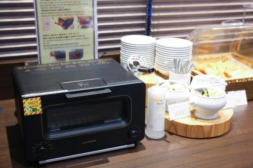 a toaster oven sitting on top of a table at Dormy Inn Matsumoto in Matsumoto