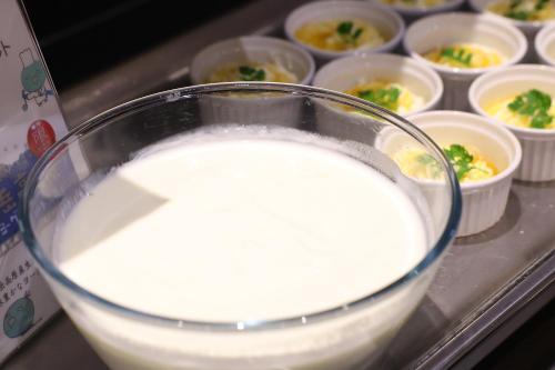 a glass bowl of milk next to cups of food at Dormy Inn Matsumoto in Matsumoto