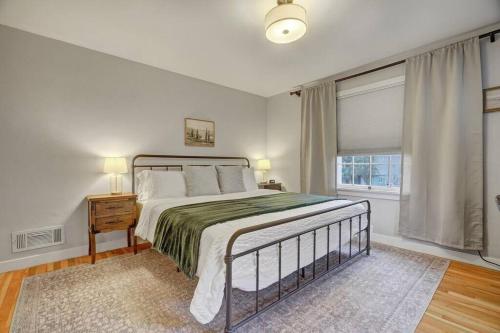 a bedroom with a large bed and a window at Kiowa Peak OCC & Downtown Basecamp in Colorado Springs