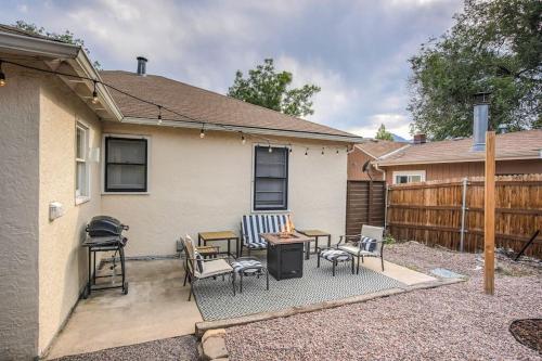 a patio with chairs and a table and a grill at Kiowa Peak OCC & Downtown Basecamp in Colorado Springs