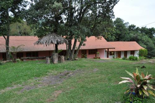 a house with a grass yard in front of it at Pousada Heritage Colonial in Nova Petrópolis