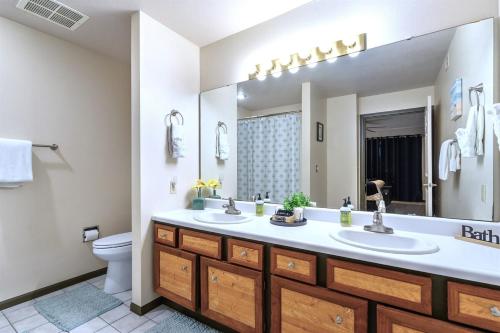 a bathroom with two sinks and a large mirror at Pointe Royale 52-7, Golf, Indoor and Outdoor Pools in Branson