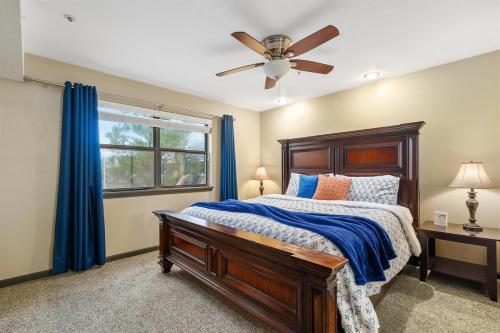a bedroom with a bed and a ceiling fan at Pointe Royale 52-7, Golf, Indoor and Outdoor Pools in Branson
