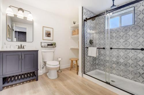 a bathroom with a shower and a toilet at Sundance Retreat 2 King Beds Downtown & Kitchen in Colorado Springs