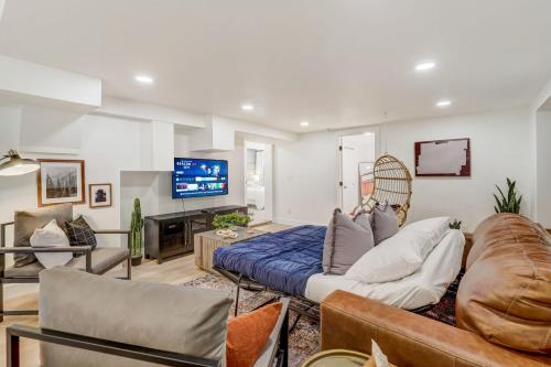 a living room with a couch and a tv at Sundance Retreat 2 King Beds Downtown & Kitchen in Colorado Springs