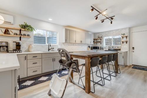a kitchen with a wooden table and chairs at Sundance Retreat 2 King Beds Downtown & Kitchen in Colorado Springs