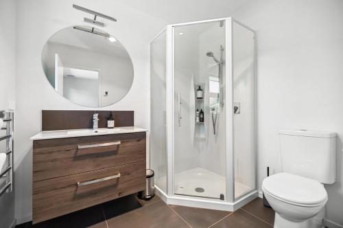 a bathroom with a shower and a toilet and a sink at Mountain View - 2 Bedroom House in Queenstown