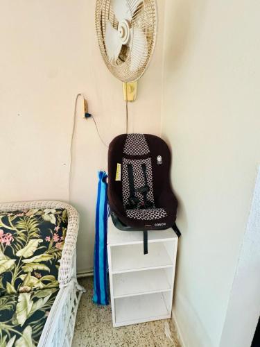 a chair sitting on a dresser next to a fan at Purple Sunset - Walk to Malecon & Beaches in Vieques
