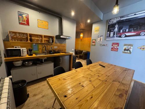 a dining room with a wooden table and a counter at Mediterranium Apartments in Póvoa de Varzim