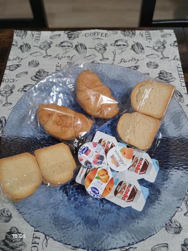 a plate of food with bread and rolls on a table at La Casa nella Contea in Terni