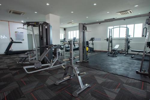 a gym with several tread machines in a room at In Centre Kuala Terengganu Home in Kuala Terengganu