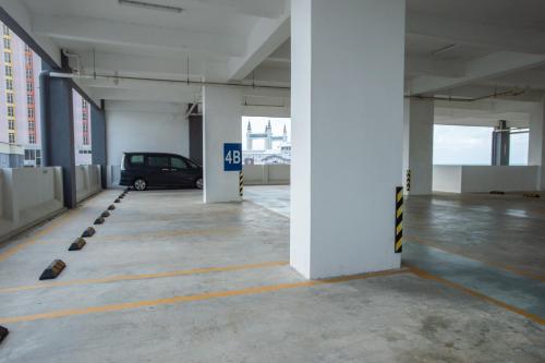 a parking garage with a car parked in it at In Centre Kuala Terengganu Home in Kuala Terengganu