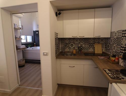 a kitchen with white cabinets and a sink at Casa Giudea in Brindisi