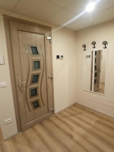 a room with a wooden door and two mirrors at Mary House in Ossimo