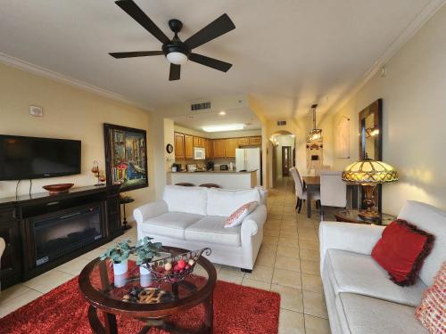 a living room with a white couch and a ceiling fan at Orlando 1st Floor - 5 min Disney in Orlando