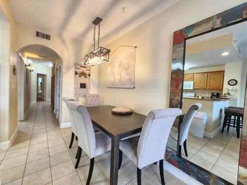 a dining room and kitchen with a table and chairs at Orlando 1st Floor - 5 min Disney in Orlando