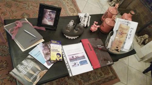 a table with books and other items on it at La Casa di Milady in Genzano di Roma