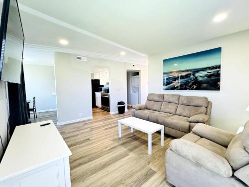 a living room with a couch and a table at Bay tree lovely one bedroom condo in Little River