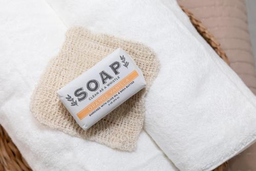 a tube of soap sitting on top of a towel at Inn At Fulton Boutique Hotel in Sandusky