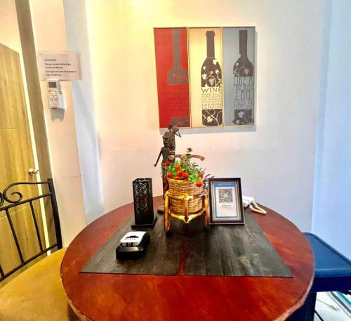 a wooden table with a vase on top of it at Ortigas Business District Residences in Manila