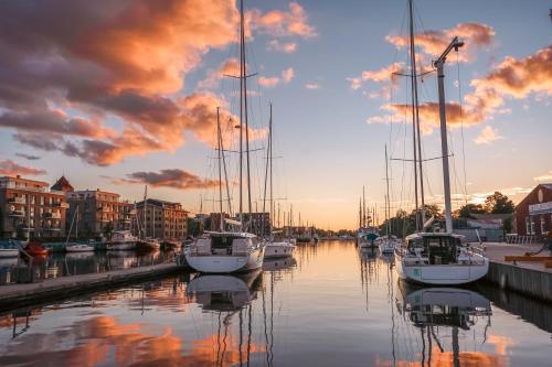 a group of boats docked in a marina at sunset at slube am Yachthafen Greifswald in Greifswald