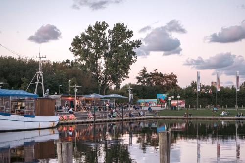 a boat is docked at a dock next to a body of water at slube am Yachthafen Greifswald in Greifswald
