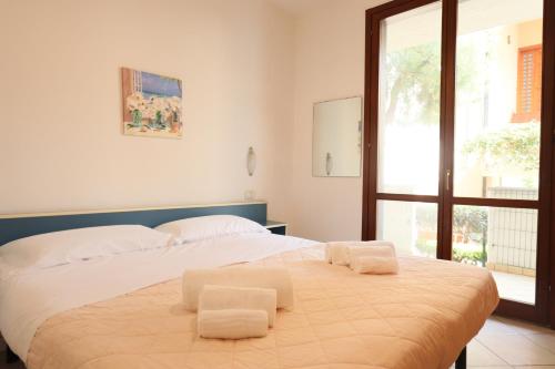 a bedroom with a large bed with two white pillows at ModernShore - Oltremare in Tortoreto Lido