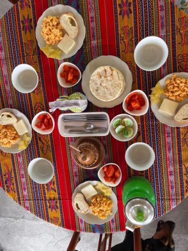 a table with many plates of food on it at Finca Hostal La Esperanza in Quimbaya