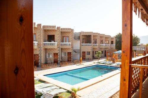a view of the pool from the balcony of a hotel at Green Beach Camp & Hotel in Nuweiba