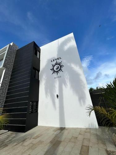 a building with a sun painted on the side of it at LEVEL suites premium in Sosúa