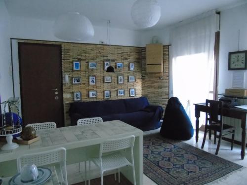 a living room with a couch and a table and chairs at Holiday Home Bergamo 1 in Bergamo