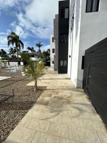 a walkway in front of a white building at LEVEL suites premium in Sosúa