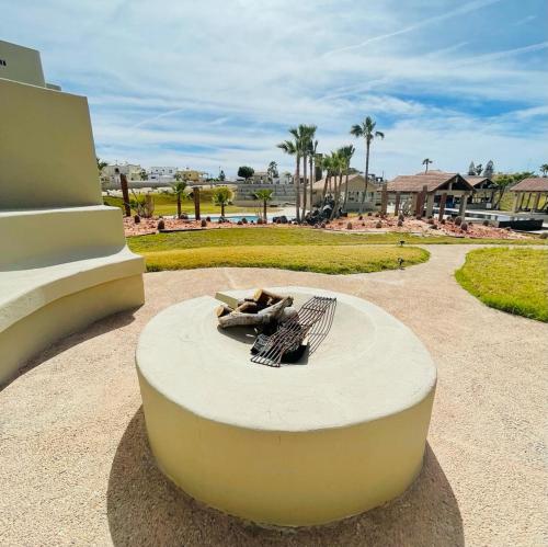 a fire pit in the middle of a park at Ocean View Condo with Pools and Easy Beach Access in Las Conchas