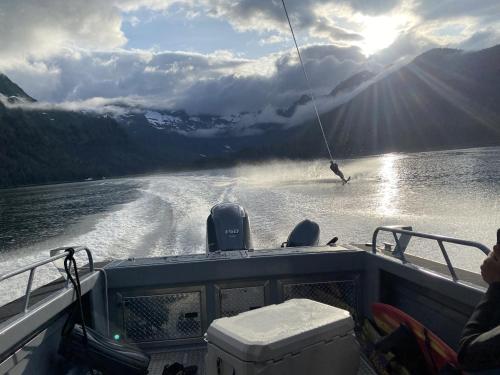 a person water skiing on a boat in the water at Accessible, Comfort, Convenient Location 106 in Juneau