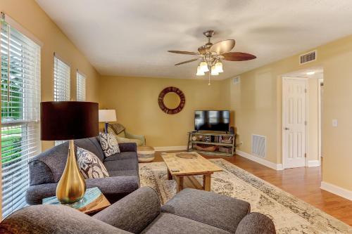 a living room with a couch and a ceiling fan at Fernandina Shores Condo in Fernandina Beach